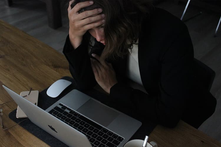 Image of a woman which is stressed out because of her work